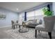 The living room features tile floors, a gray couch, two chairs, an area rug, and a front window at 3300 Needles Dr, Orlando, FL 32810