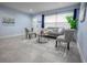 An inviting living room with tile floors, a gray couch, two chairs, and a large front window at 3300 Needles Dr, Orlando, FL 32810