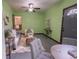 The living room has green walls and offers a view to the dining area at 3300 Needles Dr, Orlando, FL 32810