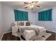 Serene main bedroom with a ceiling fan, wood floors, and a plush bed complemented by soft lighting at 3300 Needles Dr, Orlando, FL 32810