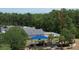 Aerial showing the neighborhood park, with a blue playground, gazebo, and surrounding trees at 3620 Benson Park Blvd, Orlando, FL 32829