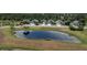 Aerial of a neighborhood with houses, pond, and lawns featuring a peaceful residential setting at 3620 Benson Park Blvd, Orlando, FL 32829