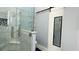 Elegant bathroom features a glass-enclosed shower, marble tiling, and a modern sliding door at 3620 Benson Park Blvd, Orlando, FL 32829