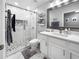Bright bathroom featuring a glass shower, marble floors, and a sleek vanity at 3620 Benson Park Blvd, Orlando, FL 32829