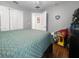 Well-lit bedroom with hardwood floors, open closet, and a view into the hallway at 3620 Benson Park Blvd, Orlando, FL 32829