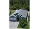 Aerial view of home with a large driveway, well-manicured lawn, and mature palm trees at 3620 Benson Park Blvd, Orlando, FL 32829