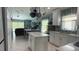 Bright, open kitchen boasts an island, stainless steel appliances and pot rack in this modern and clean design at 3620 Benson Park Blvd, Orlando, FL 32829