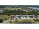 Aerial view of a quiet neighborhood with tidy homes, green spaces, and a community park by a peaceful pond at 3620 Benson Park Blvd, Orlando, FL 32829