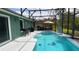 Outdoor pool with dining and cooking space, surrounded by lush landscaping at 3620 Benson Park Blvd, Orlando, FL 32829