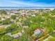 Overhead view of blue home, revealing the lush greenery surrounding the residence in a charming neighborhood at 420 S Oak Ave, Sanford, FL 32771