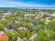 Aerial view of the blue home nestled among lush trees, highlighting the property boundaries in red at 420 S Oak Ave, Sanford, FL 32771