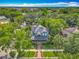 Stunning aerial view of a charming home nestled among lush trees, showcasing its beautiful architecture and landscaping at 420 S Oak Ave, Sanford, FL 32771