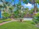 Lush backyard features palm trees, a manicured lawn, brick paths, and an outdoor seating area at 420 S Oak Ave, Sanford, FL 32771