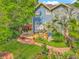 Backyard view featuring a wooden deck with dining area and lounging section with manicured landscape at 420 S Oak Ave, Sanford, FL 32771