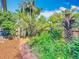 Backyard showcasing lush landscaping, a brick pathway, and a privacy fence at 420 S Oak Ave, Sanford, FL 32771