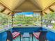 Balcony with blue wainscoting and detailed carvings providing views of a park and tree lined street at 420 S Oak Ave, Sanford, FL 32771