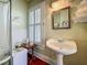 Bathroom featuring wainscoting, a pedestal sink and natural light from a window at 420 S Oak Ave, Sanford, FL 32771