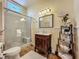 Classic bathroom featuring a glass shower and vintage vanity with a marble countertop and decorative shelving at 420 S Oak Ave, Sanford, FL 32771