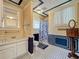 Bright bathroom featuring patterned tile floors, classic fixtures, and blue and beige paneling at 420 S Oak Ave, Sanford, FL 32771
