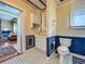Charming bathroom with blue wainscoting, white vanity, and classic fixtures next to the living room at 420 S Oak Ave, Sanford, FL 32771