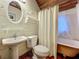Unique bathroom featuring wood accents, a pedestal sink, and a claw-foot bathtub with a shower curtain at 420 S Oak Ave, Sanford, FL 32771