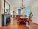 Dining area with chandelier, fireplace, hardwood floors, and decorative elements at 420 S Oak Ave, Sanford, FL 32771