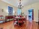 Elegant dining room with hardwood floors and period furnishings, including a buffet at 420 S Oak Ave, Sanford, FL 32771