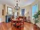 Dining area with chandelier, fireplace, hardwood floors, and decorative elements at 420 S Oak Ave, Sanford, FL 32771