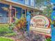 A sign for Higgins House shows lush colorful plants at the base at 420 S Oak Ave, Sanford, FL 32771