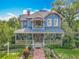 Charming two-story home with a spacious porch and beautiful landscaping at 420 S Oak Ave, Sanford, FL 32771