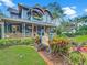 Beautiful blue Victorian home with a welcoming front porch, colorful plants, and a Higgins House sign at 420 S Oak Ave, Sanford, FL 32771