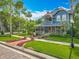 Charming two-story home with a spacious porch, manicured lawn and mature trees at 420 S Oak Ave, Sanford, FL 32771