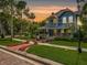 Charming two-story home with a spacious porch, manicured lawn and mature trees at 420 S Oak Ave, Sanford, FL 32771