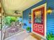 Inviting front porch with classic seating, plants and beautiful architectural details at 420 S Oak Ave, Sanford, FL 32771