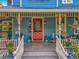 Inviting front porch with classic seating and beautiful architectural details at 420 S Oak Ave, Sanford, FL 32771