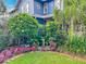 Charming blue home with a well-manicured front yard, lush landscaping, and a decorative water fountain at 420 S Oak Ave, Sanford, FL 32771