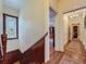 Hallway with wood floors leading to rooms and a stairwell with stained glass window and wood paneling at 420 S Oak Ave, Sanford, FL 32771