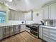 Spacious kitchen with stainless steel appliances, tile backsplash and modern fixtures at 420 S Oak Ave, Sanford, FL 32771