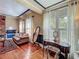 Cozy living room with wood floors, fireplace, and ample natural light from large windows at 420 S Oak Ave, Sanford, FL 32771