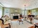 Expansive living room with fireplace, piano, vintage furniture and many windows at 420 S Oak Ave, Sanford, FL 32771