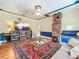 Inviting living room with hardwood floors, a brick fireplace and blue accents at 420 S Oak Ave, Sanford, FL 32771
