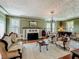 Expansive living room with fireplace, piano, vintage furniture and many windows at 420 S Oak Ave, Sanford, FL 32771