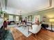 Bright living room with vintage furniture, hardwood floors, and seamless doorways to other rooms at 420 S Oak Ave, Sanford, FL 32771