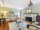 Inviting living room with a cozy fireplace, decorative furniture, and bright natural lighting at 420 S Oak Ave, Sanford, FL 32771