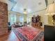 Spacious living room with exposed brick, hardwood floors and a decorative ceiling at 420 S Oak Ave, Sanford, FL 32771