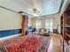 Spacious living room features a decorative ceiling, brick fireplace, and large area rug at 420 S Oak Ave, Sanford, FL 32771