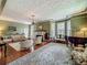 Spacious living room with hardwood floors, fireplace, and large windows at 420 S Oak Ave, Sanford, FL 32771