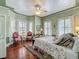 Charming main bedroom featuring hardwood floors, a ceiling fan, and lots of natural light at 420 S Oak Ave, Sanford, FL 32771