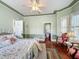 Light and airy main bedroom with hardwood floors and stylish decor at 420 S Oak Ave, Sanford, FL 32771