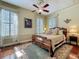 Inviting main bedroom with ornate wood bed, vintage rugs, and natural light at 420 S Oak Ave, Sanford, FL 32771